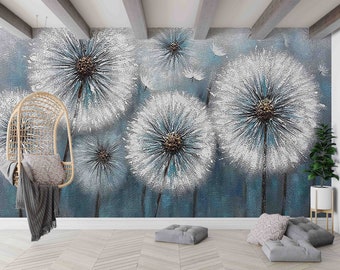 May include: A wall mural featuring large, textured dandelions in white and teal against a teal background. A hanging wicker chair with a gray blanket and pillow is in the foreground. The room has wooden floors and a plant.
