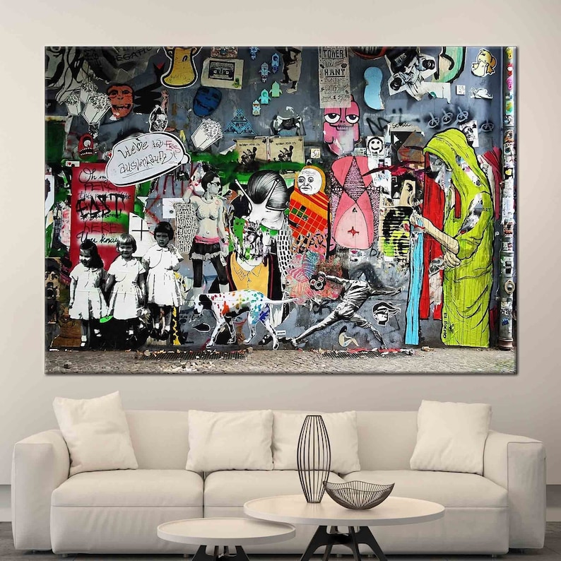 May include: A colorful and abstract wall mural with a variety of figures, animals, and text. The mural is made up of different colors and textures, including red, green, blue, yellow, and black. The mural is a unique and eye-catching piece of art.