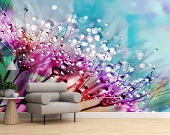 May include: A vibrant floral wallpaper featuring a close-up of a dandelion seed head with water droplets. The image showcases a blend of pink, purple, and blue hues, creating a dreamy and artistic aesthetic. A modern gray armchair and a small side table are in the foreground.