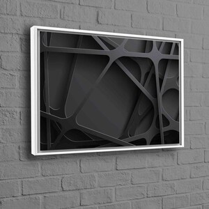May include: Black and white abstract geometric design framed in a white frame. The design features overlapping lines and shapes creating a 3D effect.
