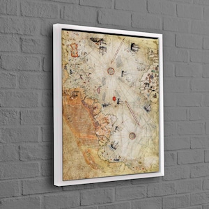 May include: An antique nautical map with a compass rose and handwritten text in a white frame. The map is printed on aged paper with a yellowed hue and shows the coastline of a landmass with a compass rose in the center.
