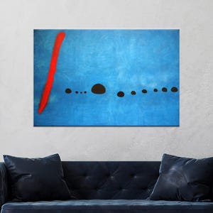 May include: Abstract art print with a textured blue backdrop, a striking red vertical line on the left, and a series of black, rounded shapes across the centre. The artwork is displayed above a dark blue sofa, adding a modern touch to the room.
