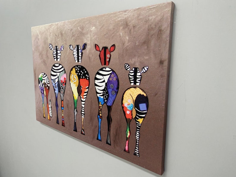 May include: A colorful painting of seven zebras with their backs to the viewer. The zebras are painted in a variety of colors, including black, white, red, yellow, blue, green, and purple. The zebras are standing in a line, and the background is a brown color.