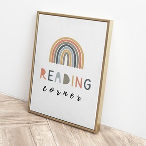 May include: A gold framed canvas print with a rainbow design and the text "READING corner" in a colourful font.