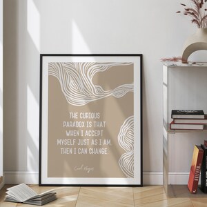 May include: A beige and white printable wall art print with a quote by Carl Rogers: "The curious paradox is that when I accept myself just as I am, then I can change."