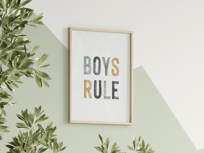 May include: A framed print with the text "BOYS RULE" in colorful, stylized lettering. The print is on a white background and has a light wood frame.