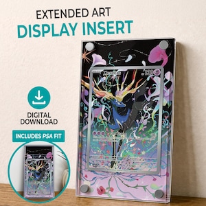 May include: An extended art display insert for a trading card featuring a Xerneas illustration with colorful floral accents on a black background. The display includes text reading EXTENDED ART DISPLAY INSERT, DIGITAL DOWNLOAD, and INCLUDES PSA FIT.