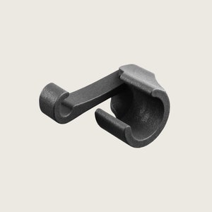 May include: Black plastic hook with a curved design. The hook has a small loop at the end and a cylindrical base.