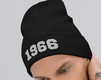 May include: Black beanie with the year 1966 embroidered in white on the front.