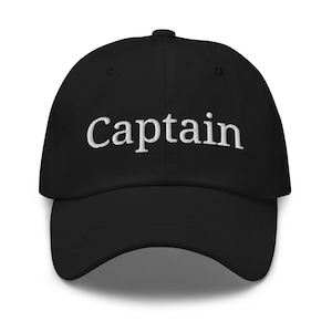 May include: Black baseball cap with white embroidered text that reads "Captain".