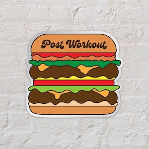 May include: A sticker of a cartoon burger with the text "Post Workout" on the top bun. The burger has lettuce, tomato, cheese, and a brown patty.