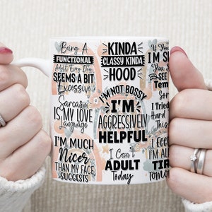 May include: White ceramic mug with a colourful design featuring text phrases like "Being a Functional Adult Every Day Seems a Bit Excessive", "Kinda Classy Kinda Hood", "I'm Not Bossy I'm Aggressively Helpful", and "I Can't Adult Today".