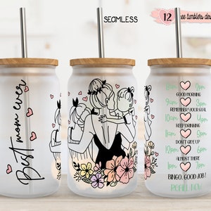 May include: Three frosted glass tumblers with bamboo lids and stainless steel straws. One tumbler reads "Best mom ever" with hearts. Another features a mother and children illustration. The third has a hydration schedule. "12 free tumblers designs included" is written on the top right.