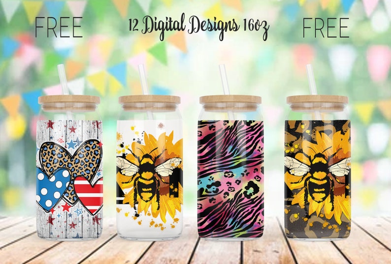 May include: Four glass tumblers with bamboo lids and straws. Designs include patriotic hearts, a bee on a sunflower, a zebra and leopard print, and a bee on a sunflower. The text reads "FREE 12 Digital Designs 16oz FREE".