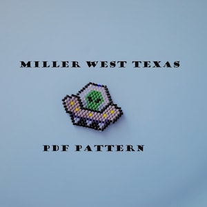 May include: A beaded UFO with a green alien inside. The UFO is pink, white, and blue with yellow stars. The text "MILLER WEST TEXAS PDF PATTERN" is printed below the UFO.