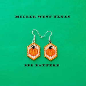 May include: A pair of beaded earrings with a pumpkin design. The earrings are hexagonal with orange and white beads forming the pumpkin and a black stem. The text "MILLER WEST TEXAS" and "PDF PATTERN" are above and below the earrings.