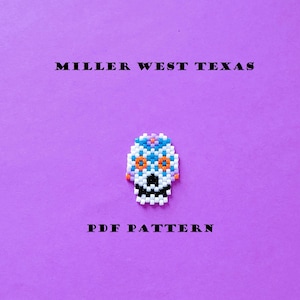 May include: A beaded skull design in white, black, orange, and blue, set against a purple background. The text "MILLER WEST TEXAS" and "PDF PATTERN" are displayed in black, adding context to the design.