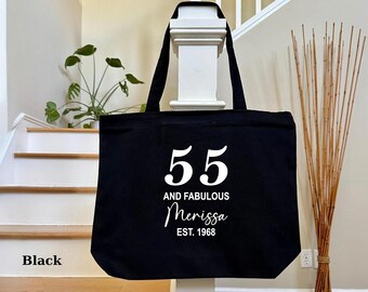 May include: Black canvas tote bag with white text that reads "55 and Fabulous Merissa Est. 1968".