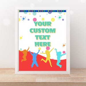 May include: A framed print with a white border. The design features colourful silhouettes of people jumping, with the text "YOUR CUSTOM TEXT HERE" in turquoise. The top border has stars and circles.