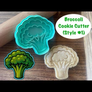 May include: A teal broccoli-shaped cookie cutter next to a baked cookie in the same shape. A cartoon broccoli illustration is also shown. The text reads "Broccoli Cookie Cutter (Style #1)".