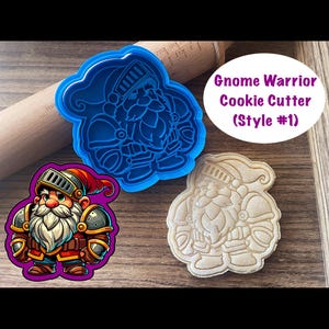 May include: Blue plastic cookie cutter shaped like a gnome warrior wearing armor. The gnome has a beard and a red hat. A cookie cut with the cutter is shown next to it.