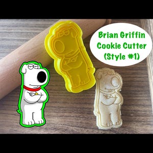 May include: A yellow plastic cookie cutter shaped like Brian Griffin from Family Guy. The cutter is shown next to a cookie that has been cut out using the cutter. The text "Brian Griffin Cookie Cutter (Style #1)" is shown in green text on a white background.