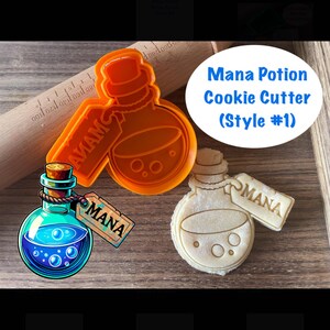 May include: Orange plastic cookie cutter shaped like a potion bottle with a tag that says "MANA". A blue and white illustration of a potion bottle with a tag that says "MANA" is shown next to the cutter. A brown wooden rolling pin is in the background. The text "Mana Potion Cookie Cutter (Style #1)" is shown in white text on a blue circle.