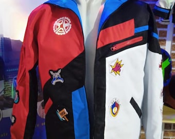 May include: A black, blue, red, and white jacket with a zipper closure and multiple colorful patches. The patches feature various designs, including a gear, a star, a sword, and a hammer.
