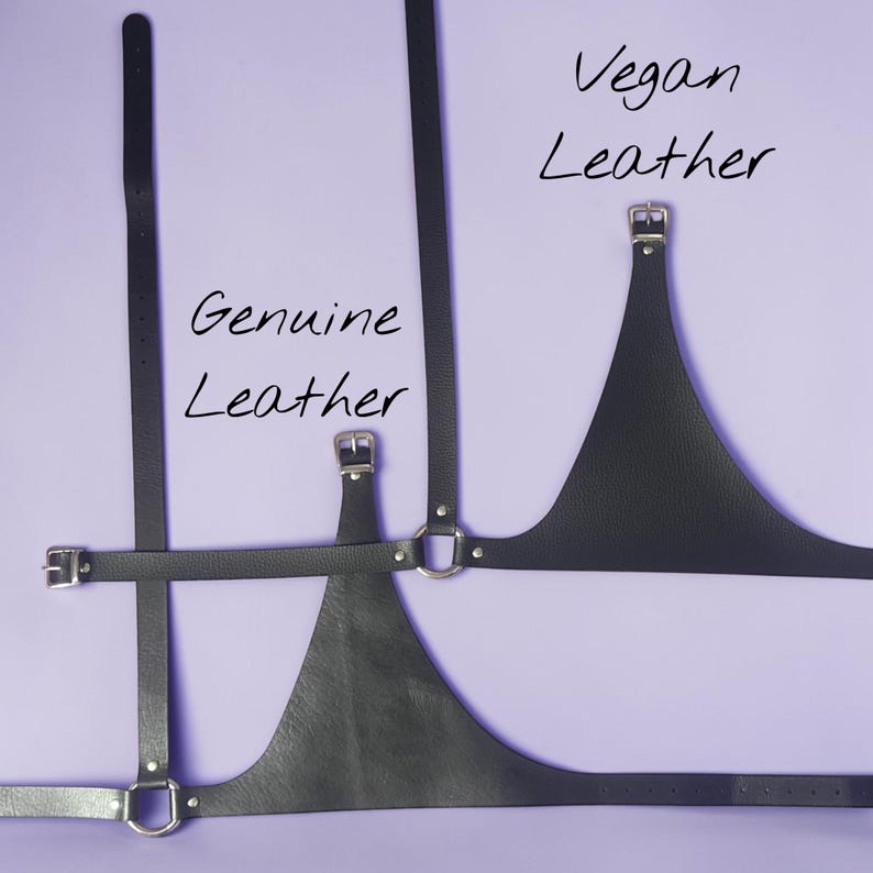 May include: Black leather harness with silver-tone hardware. The image shows two styles, one labeled "Genuine Leather" and the other "Vegan Leather". The harness features adjustable straps and a triangular chest piece, set against a lavender background.