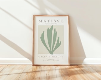 May include: A framed print of a Matisse artwork titled "Papiers Decoupes" featuring a green abstract leaf design. The print includes the text "Matisse", "Galerie Maeght", "Paris 1954", and "13 Rue de Téhéran, Paris VIII".