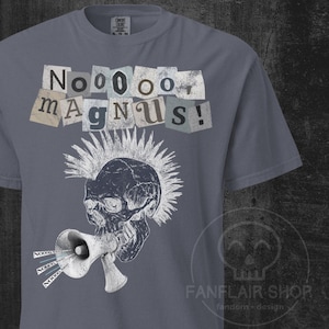 May include: A grey t-shirt with a punk skull design. The skull has a mohawk and is shouting through a megaphone. The text "Nooooo Magnus!" is above the skull in a collage style. The shirt has a crew neck and short sleeves.