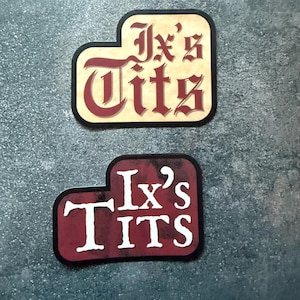 Crowns of Nyaxia // Serpent & the Wings of Night -- Ix's Tits! -- Matte vinyl waterproof sticker