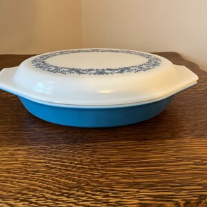 May include: An oval casserole dish with a lid, in blue and white. The lid has a blue floral design around the edge.