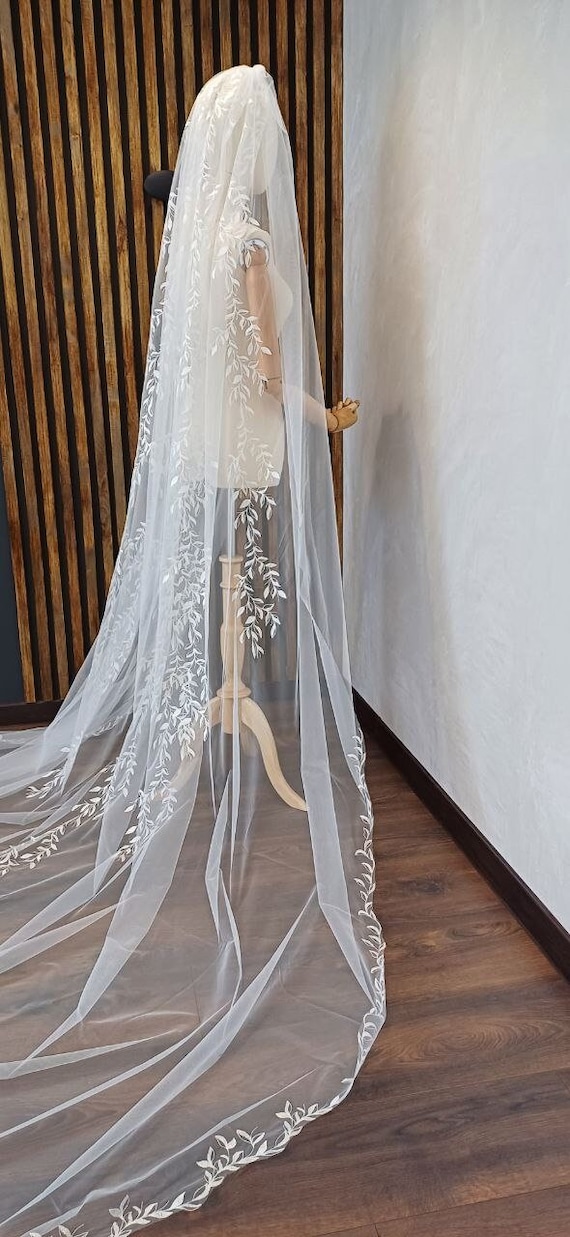 Wedding veil with embroidered leaves from the comb and a train of the veil in one tier on the comb
