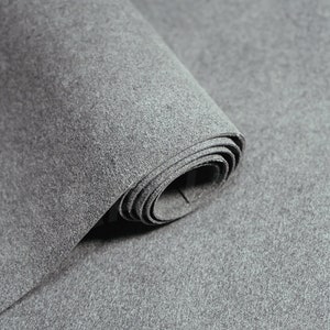 May include: A roll of gray felt fabric. The fabric is soft and has a slightly textured surface.