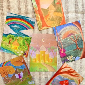 May include: Set of six illustrated cards featuring whimsical scenes with a rainbow, a castle, a fairy, a mushroom, a tree, and a sunset. The cards are printed on thick cardstock and have a matte finish.