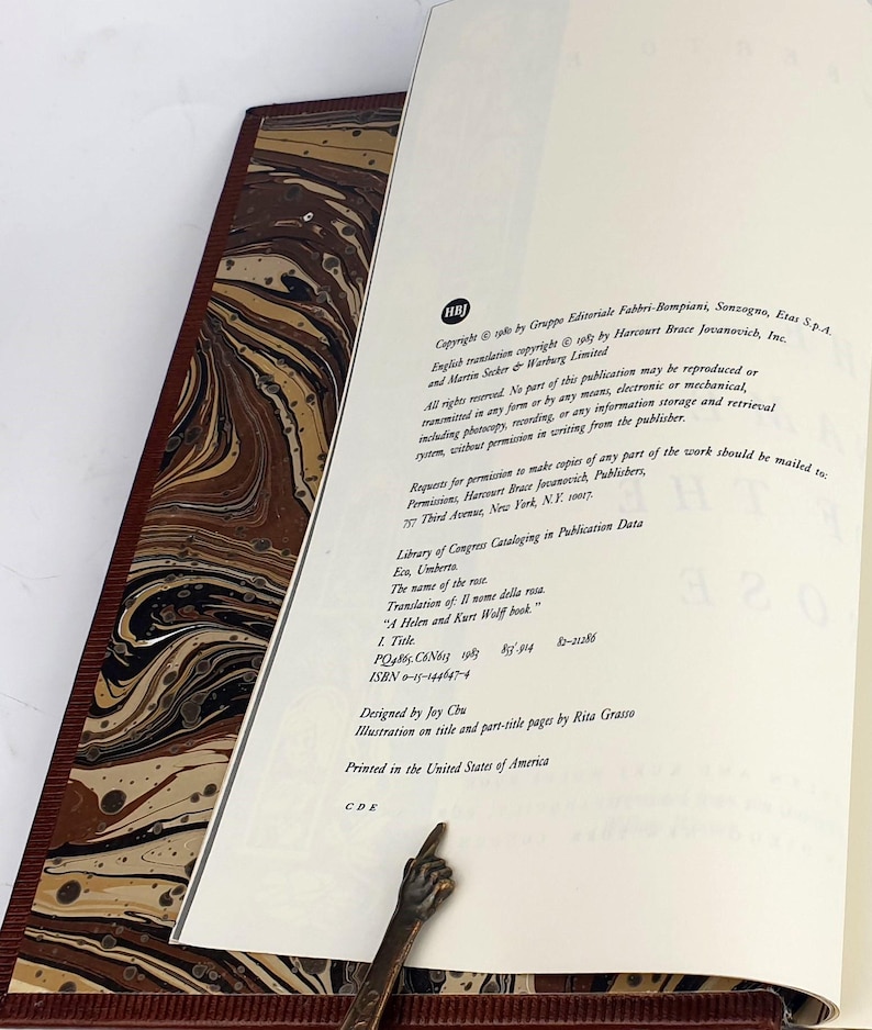 K&ouml;nnte beinhalten: Eine Nahaufnahme der Copyright- und Verlagsinformationen einer Buchseite. Die Seite ist wei&szlig; mit schwarzem Text. Der Text enth&auml;lt den Titel "Der Name der Rose" und den Autor "Umberto Eco".