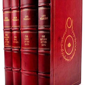May include: A collection of four books with red leather covers and gold lettering. The titles include "The Fellowship of the Ring", "The Two Towers", "The Lord of the Rings", and "The Return of the King" by J.R.R. Tolkien. The rightmost book has a gold illustration.