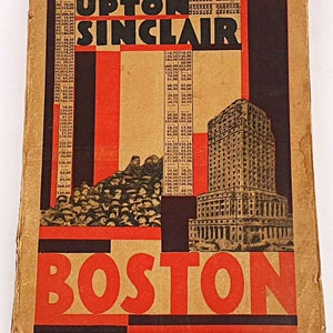 May include: A vintage book cover with the title "UPTON SINCLAIR" in bold red letters. The cover features a black and white image of a tall building in Boston, Massachusetts. The cover also includes a black and white image of a crowd of people.