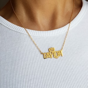 May include: Gold necklace with a pumpkin-shaped pendant and the name "TAYLOR" spelled out in a spooky font.