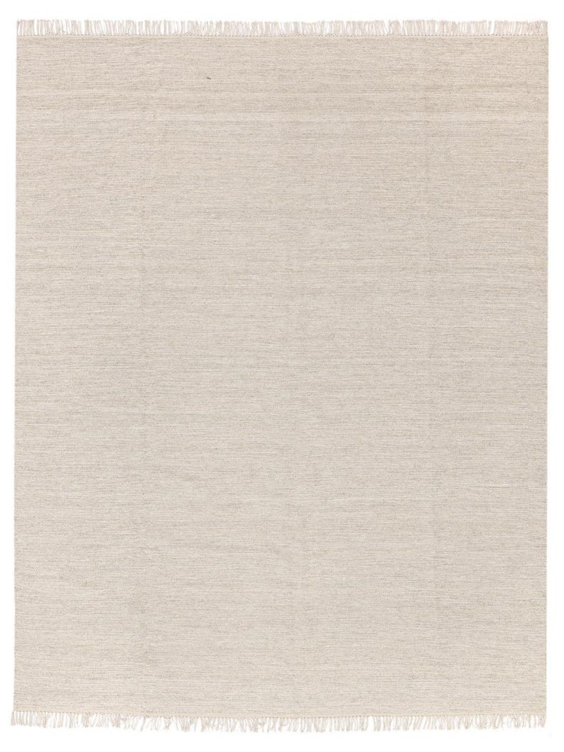 May include: A plain, off-white woven rug with a fringed edge.