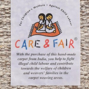 May include: White label with the text "For Children's Welfare - Against Child Labour" and the logo "CARE & FAIR" with two children sitting on a red rug. The text below the logo reads "With the purchase of this hand-made carpet from India, you help to fight illegal child labour and contribute towards the welfare of children and weavers' families in the carpet weaving areas."