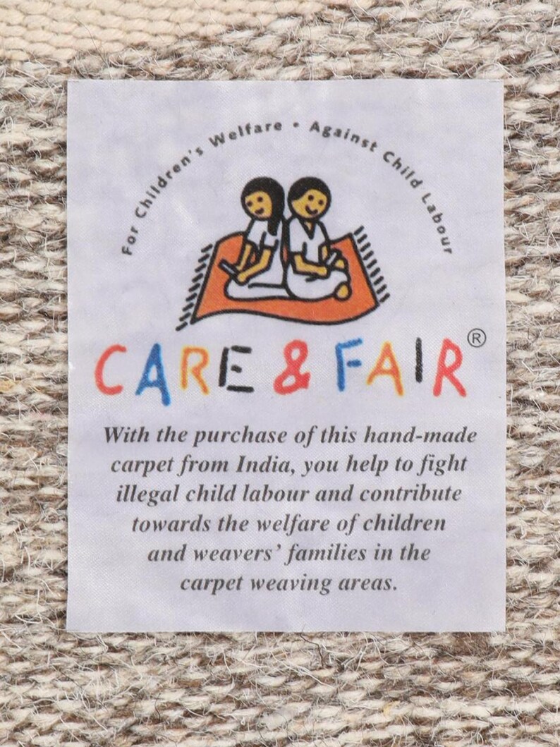 May include: White label with the text "For Children's Welfare - Against Child Labour" and the logo "CARE & FAIR" with two children sitting on a red rug. The text below the logo reads "With the purchase of this hand-made carpet from India, you help to fight illegal child labour and contribute towards the welfare of children and weavers' families in the carpet weaving areas."