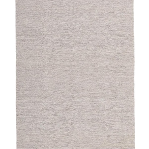May include: A light gray area rug with a subtle woven texture and fringe edging.