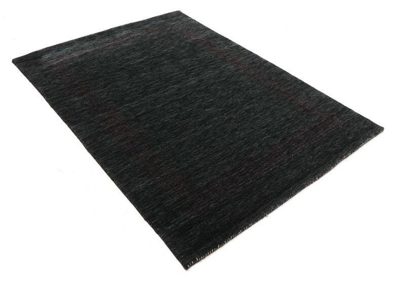 May include: A dark gray area rug with a subtle, textured pattern. The rug has a slightly faded look, giving it a vintage feel.