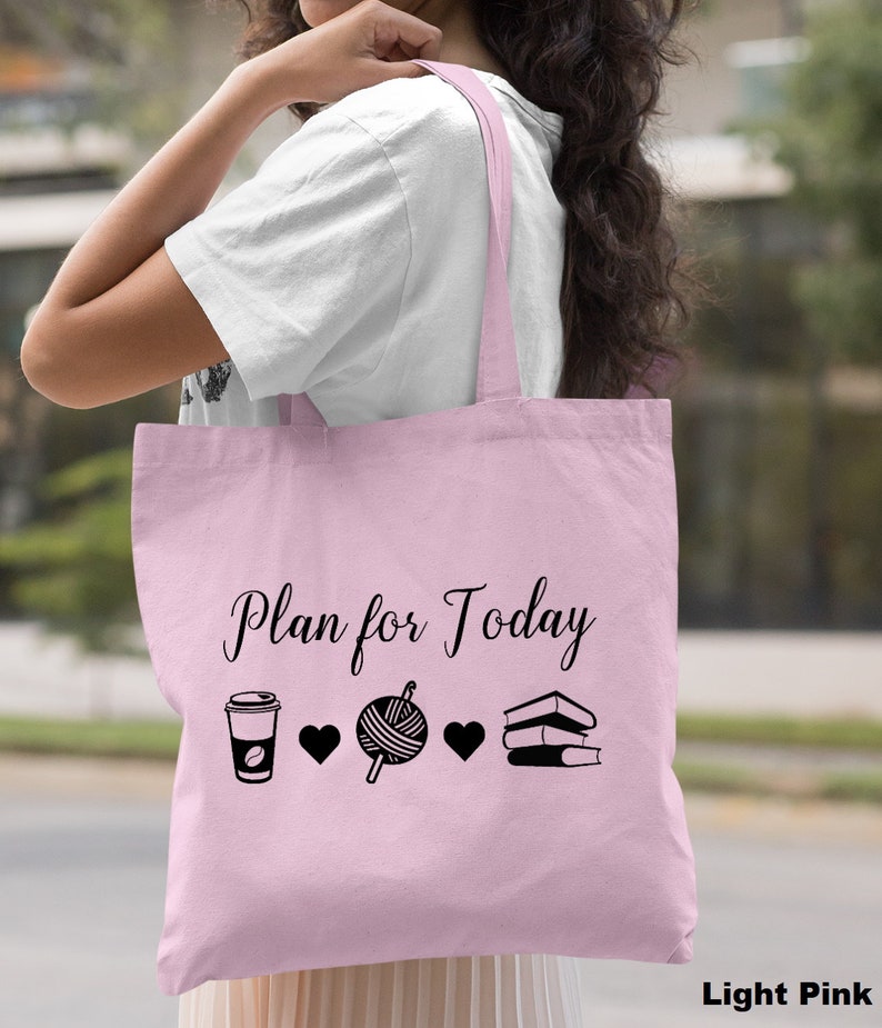 May include: Light pink tote bag with the text "Plan for Today" and black icons of a coffee cup, yarn, and books.