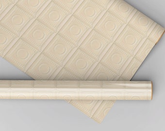 May include: Cream-colored wallpaper rolls with a repeating square pattern featuring a central circle and decorative detailing. The rolls are partially unrolled, showcasing the textured design. The wallpaper is suitable for interior decoration.