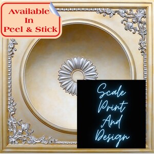 May include: A decorative ceiling tile with a gold frame and a central medallion design. The medallion is silver and has a floral pattern. The text "Available In Peel & Stick" is in the upper left corner. The text "Scale Print And Design" is in the lower right corner.