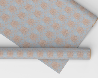 May include: A roll of blue wrapping paper with a delicate, light brown floral pattern. The paper is rolled up and the end is visible.
