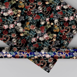 May include: A roll of wrapping paper featuring a dark black background with a repeating pattern of human skulls, coiled brown snakes, and clusters of red, pink, white, and yellow roses with green leaves. The paper is displayed partially unrolled.